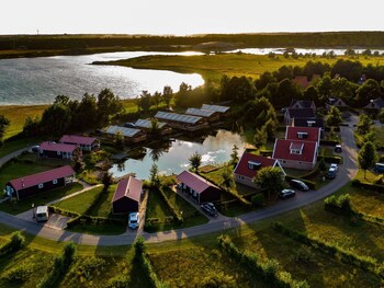 combined chalets with a bathroom located near a pond