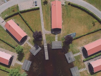 combined chalets with a bathroom located near a pond
