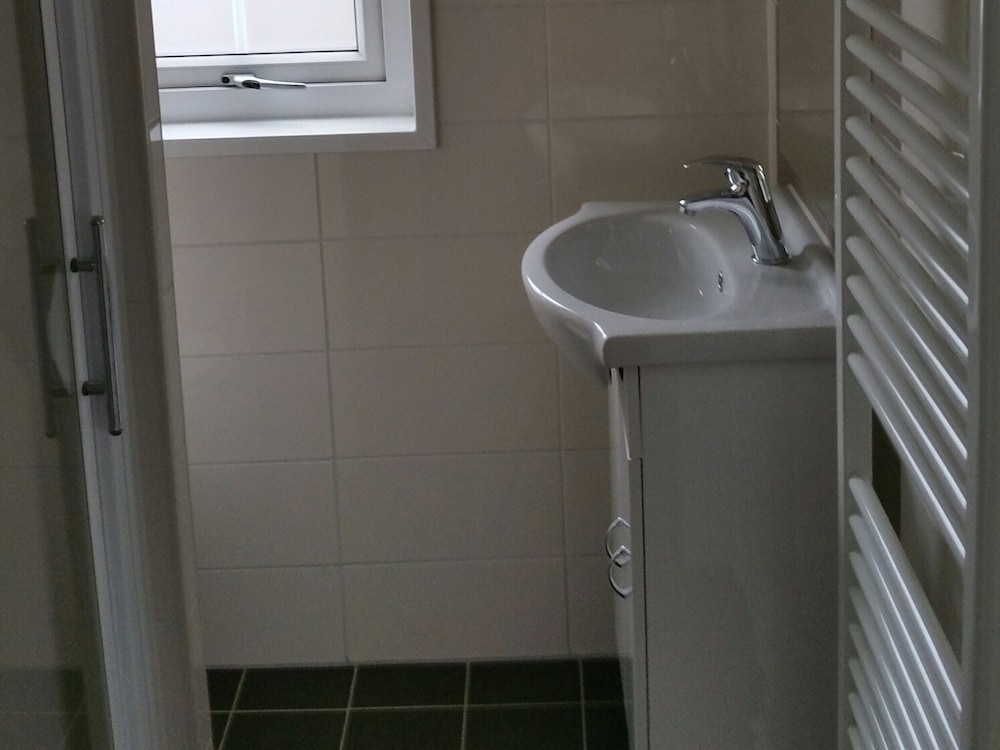 combined chalets with a bathroom located near a pond