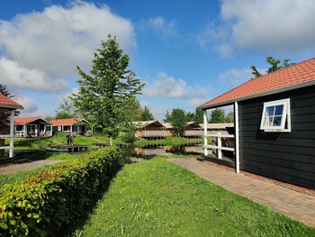 combined chalets with a bathroom located near a pond
