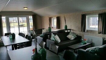 combined chalets with a bathroom located near a pond