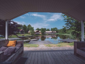 combined chalets with a bathroom located near a pond
