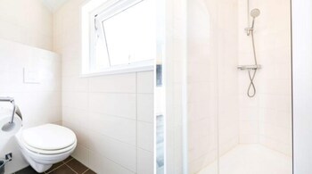 combined chalets with a bathroom located near a pond