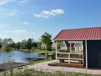 combined chalets with a bathroom located near a pond