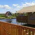 campsite combined tents with kitchen and bathroom located near a pond
