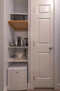 one hotel room with king bed and ac