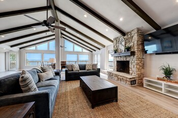 waterfront lake house with hot tub and firepit