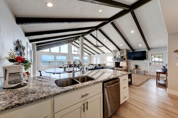 waterfront lake house with hot tub and firepit