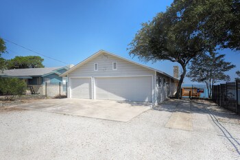 waterfront lake house with hot tub and firepit