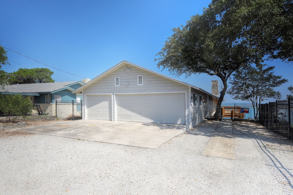 waterfront lake house with hot tub and firepit