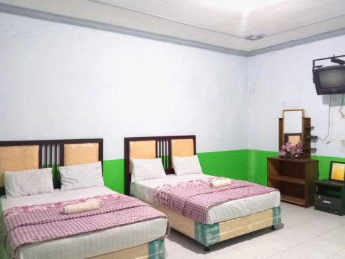 puspa tiara syari guci mitra reddoorz