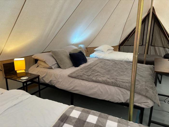 cozy hot tent with log burner and hot tub right tent