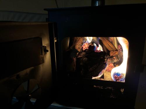 cozy hot tent with log burner and hot tub right tent