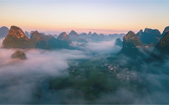 cindy villa rice fields and karst peaks at yulong river infinity pool