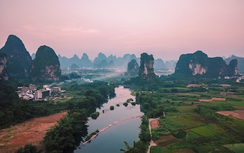 cindy villa rice fields and karst peaks at yulong river infinity pool