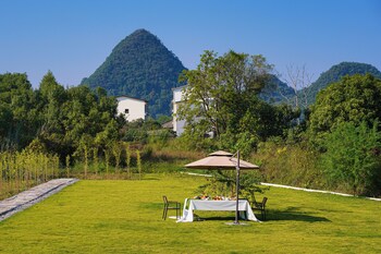 cindy villa rice fields and karst peaks at yulong river infinity pool