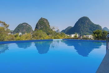 cindy villa rice fields and karst peaks at yulong river infinity pool