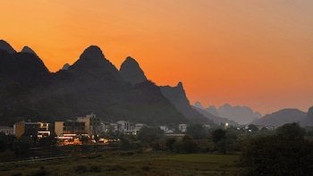 cindy villa rice fields and karst peaks at yulong river infinity pool