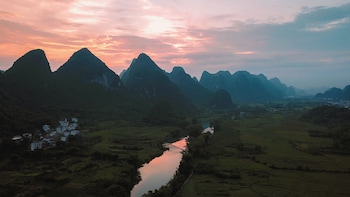 cindy villa rice fields and karst peaks at yulong river infinity pool