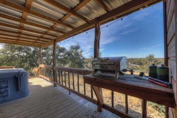 mesquite cabin with hot tub and hill country views