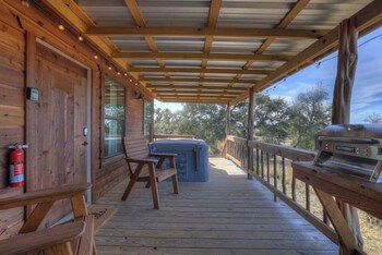 mesquite cabin with hot tub and hill country views