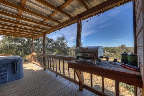 mesquite cabin with hot tub and hill country views